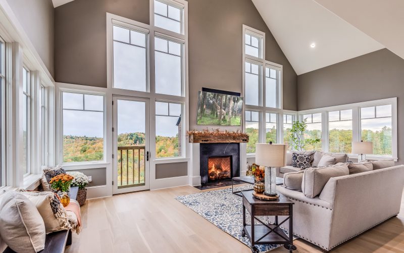 Open and spacious room with a lot of windows surrounding the fireplace